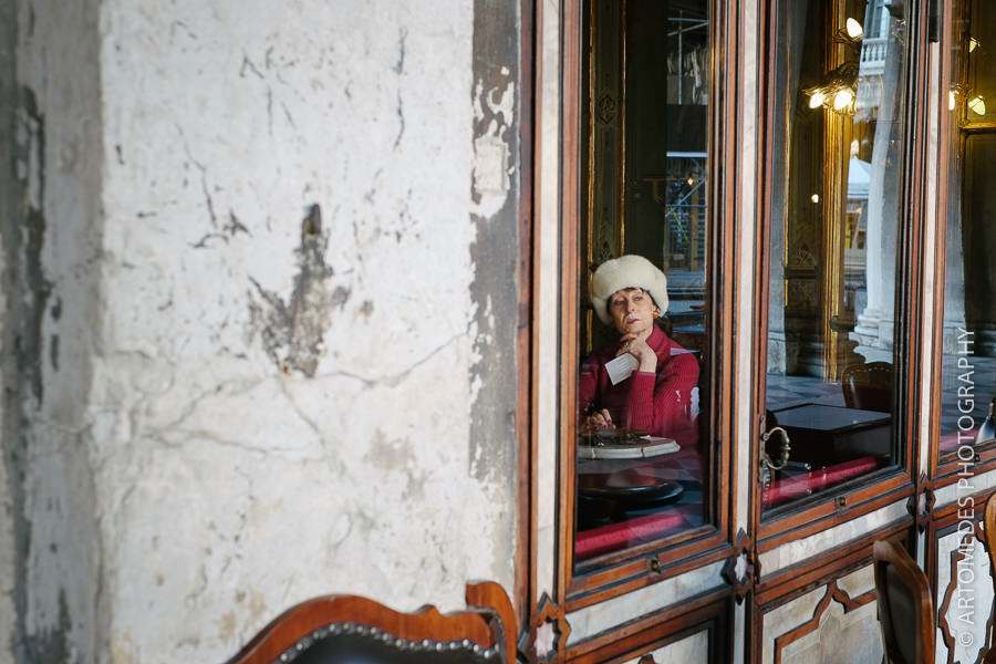woman sitting in venice cafe looking out of the window