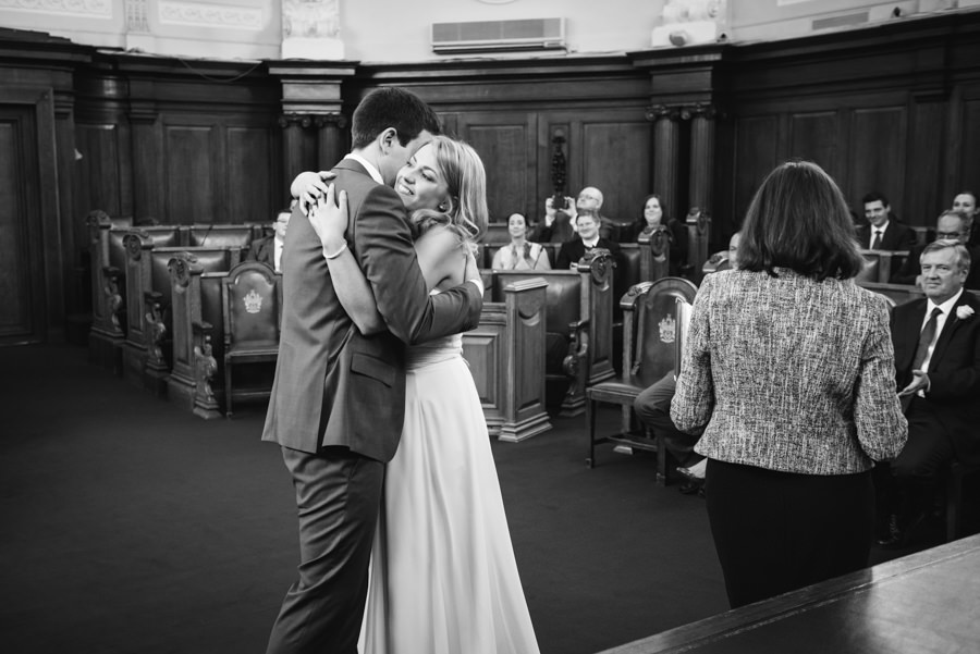 Just married! Newly weds hugging.