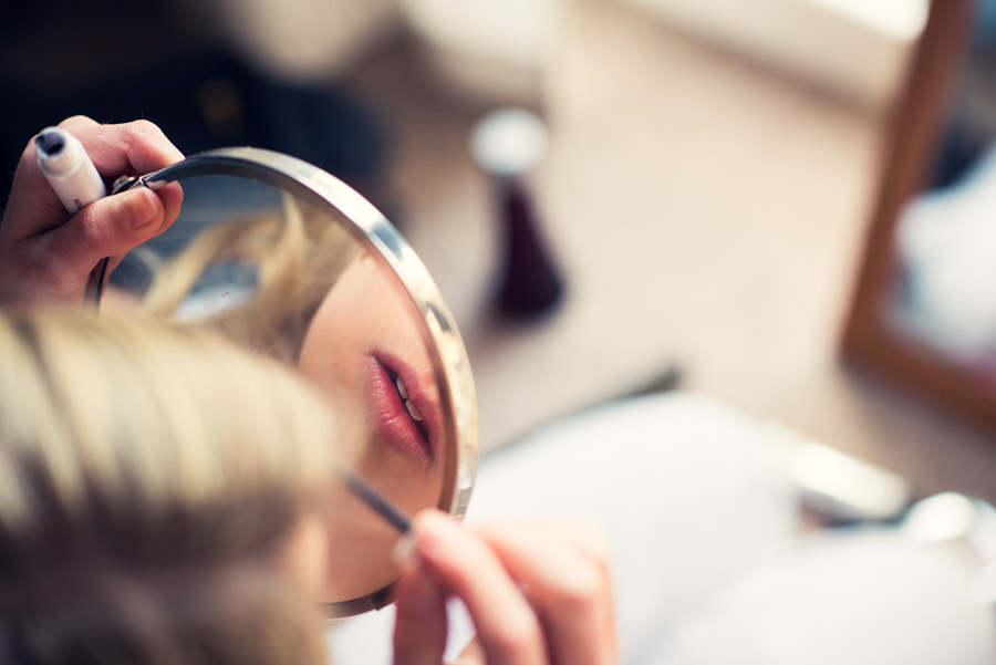 photo of brides lips reflected in mirror as she's getting ready for her wedding at Islington town hall