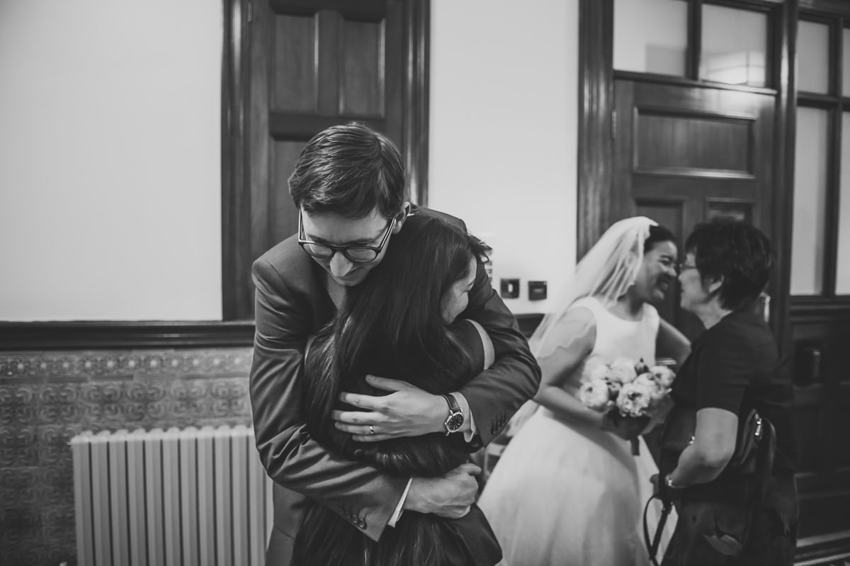 Newly weds hugging guests at their Surrey Wedding