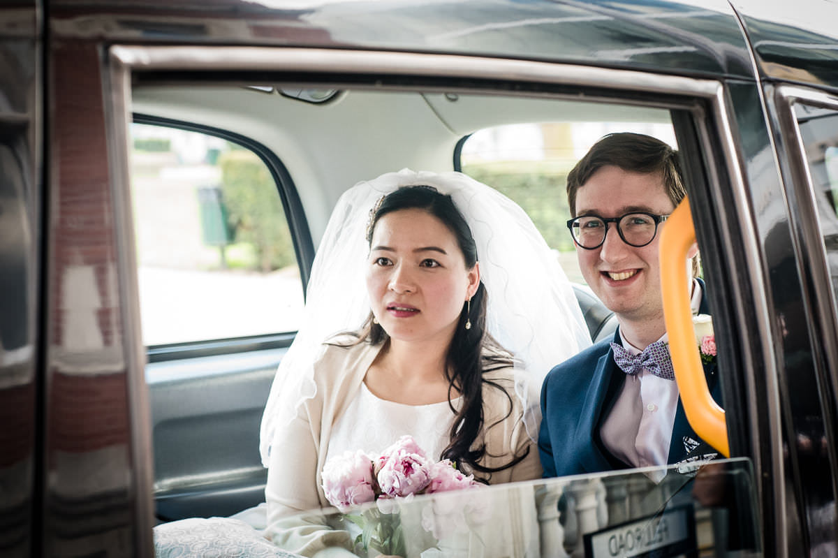 The bride and groom waiting in a taxi outside Croydon Registry office