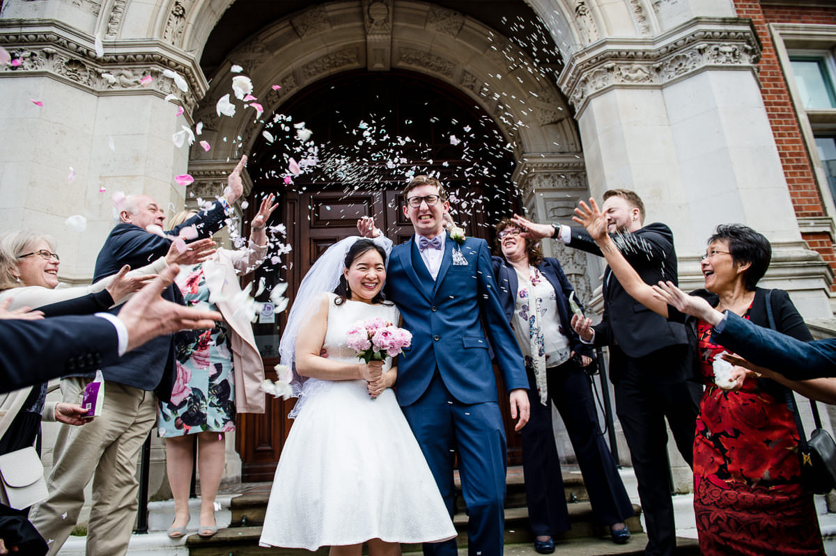 Bride & Groom being covered in confetti on the steps of Croydon Old Town hall