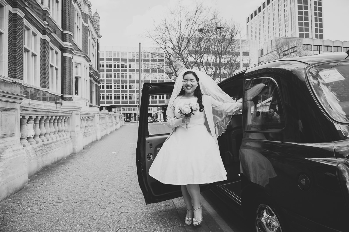 Spring Bride arrives at her croydon registry office wedding in black taxi