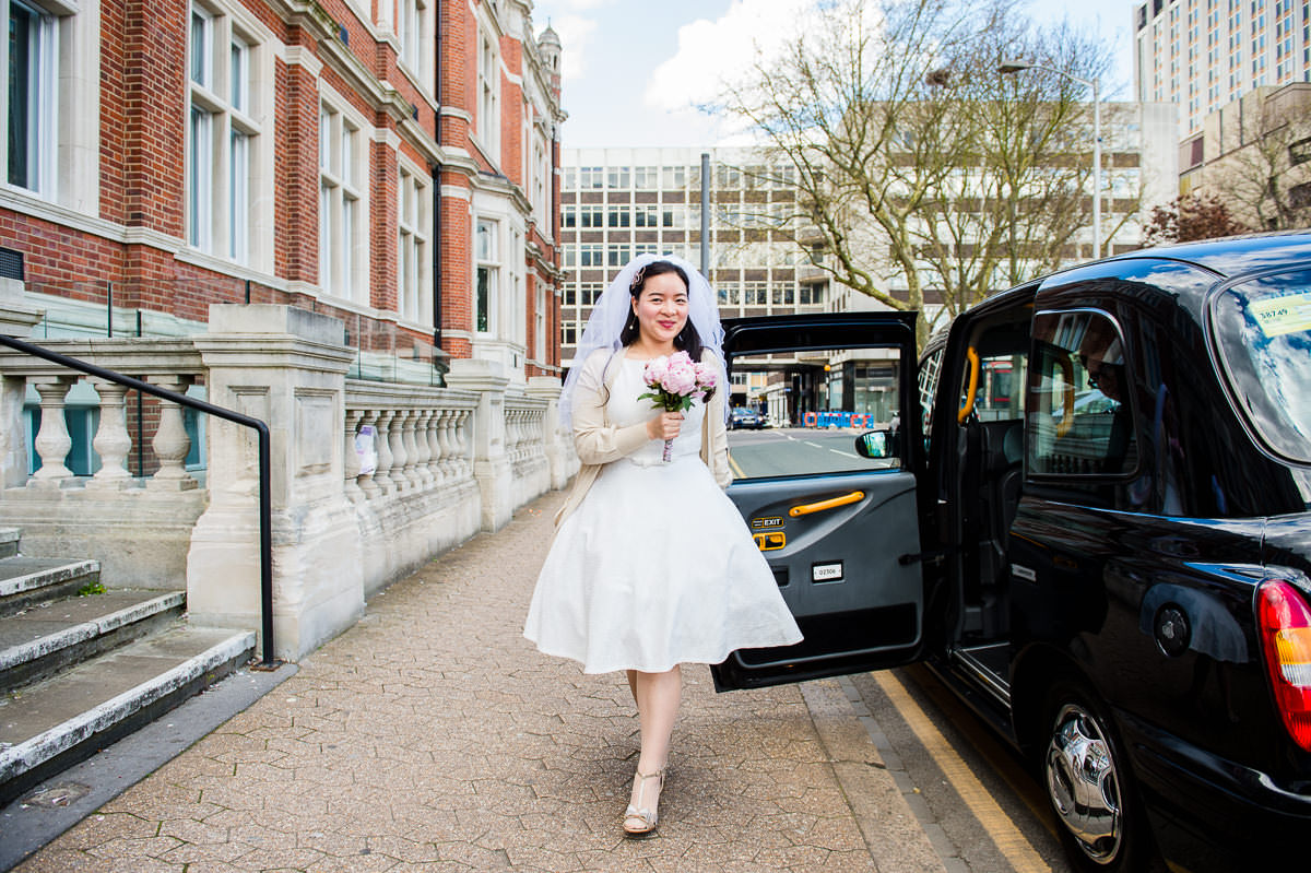 Stylish spring bride with short dress and bouquet