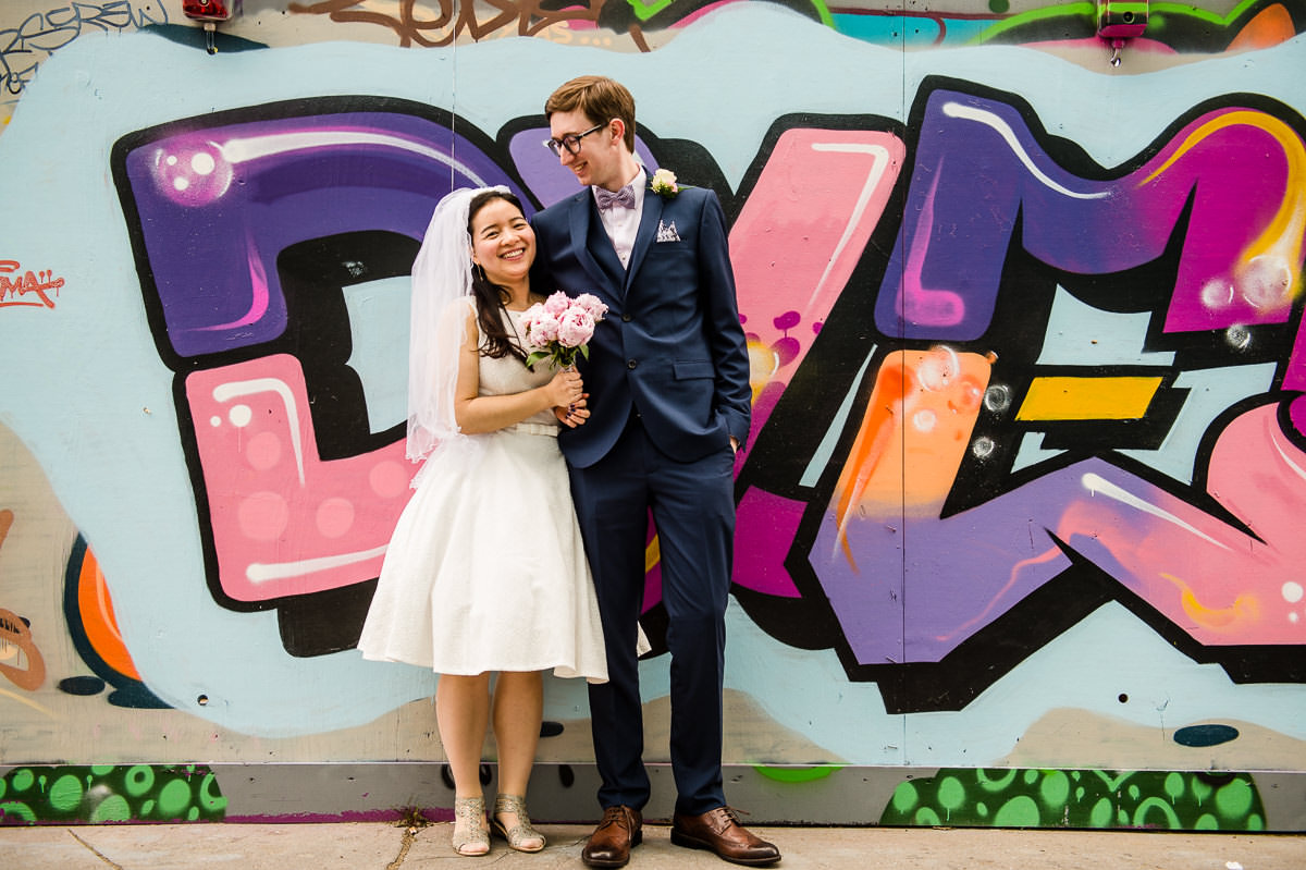 Bride and Groom in front of graffiti wall after their Croydon Registry office wedding