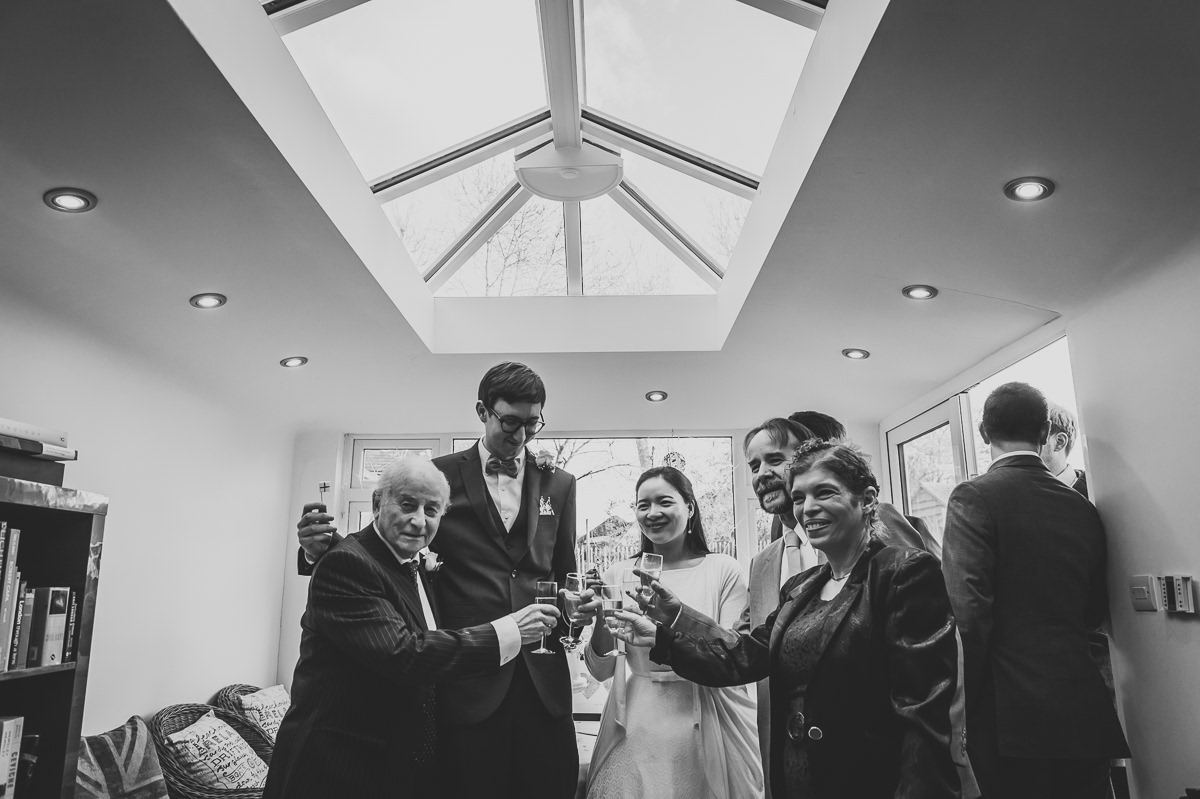 Guests celebrating with the newly weds at their surrey garden wedding