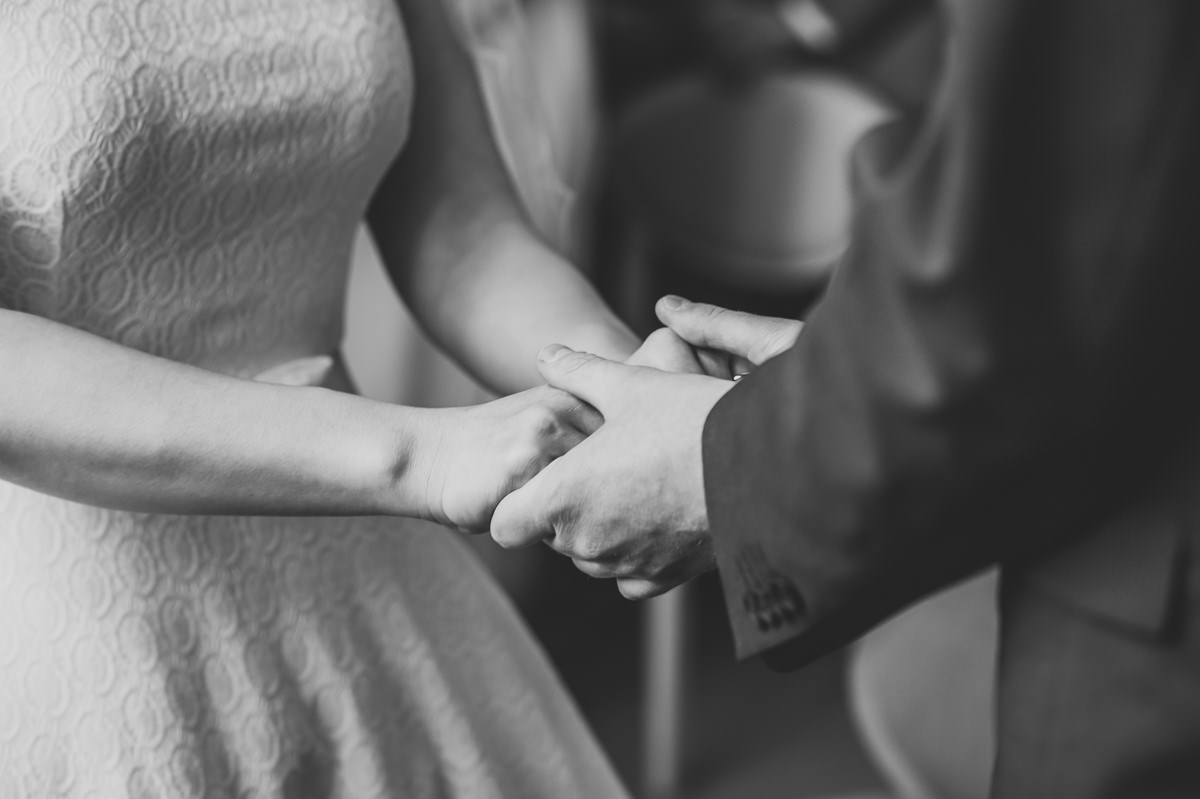 Bride and Groom holding hands during their wedding ceremony at Croydon Registry office