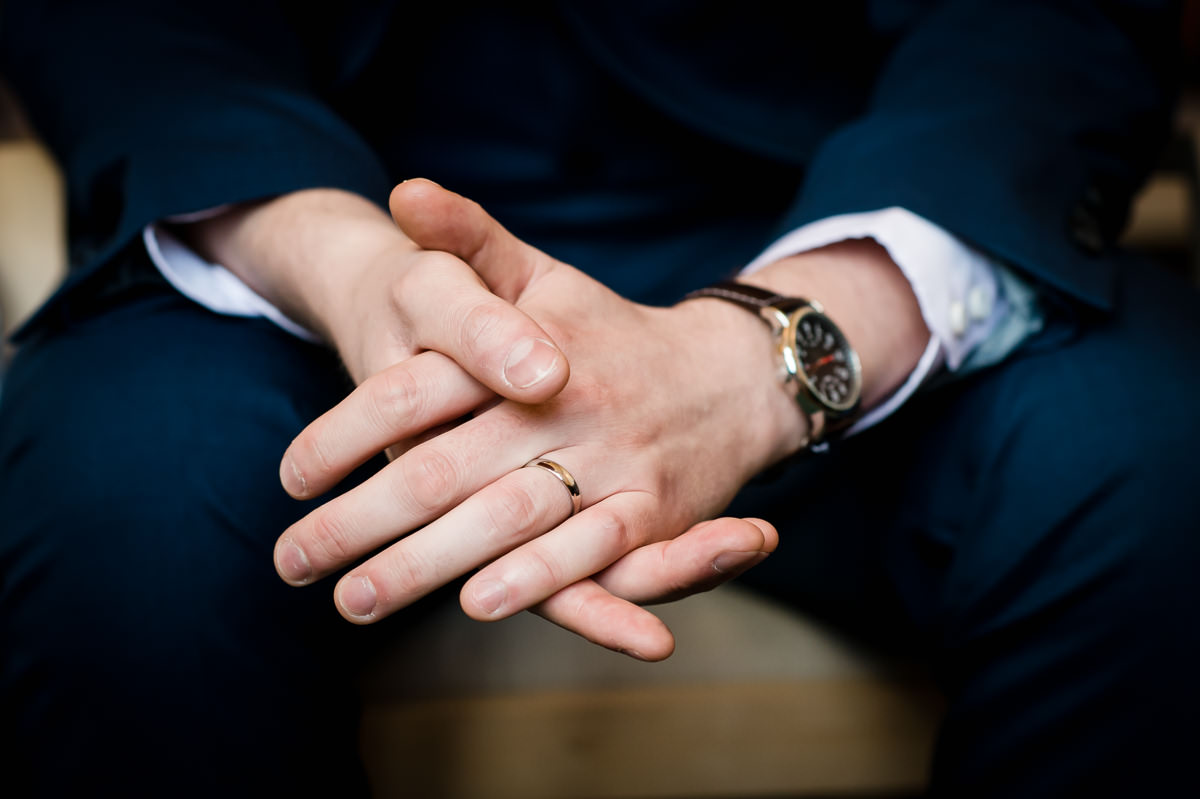 Groom's hands and wedding ring