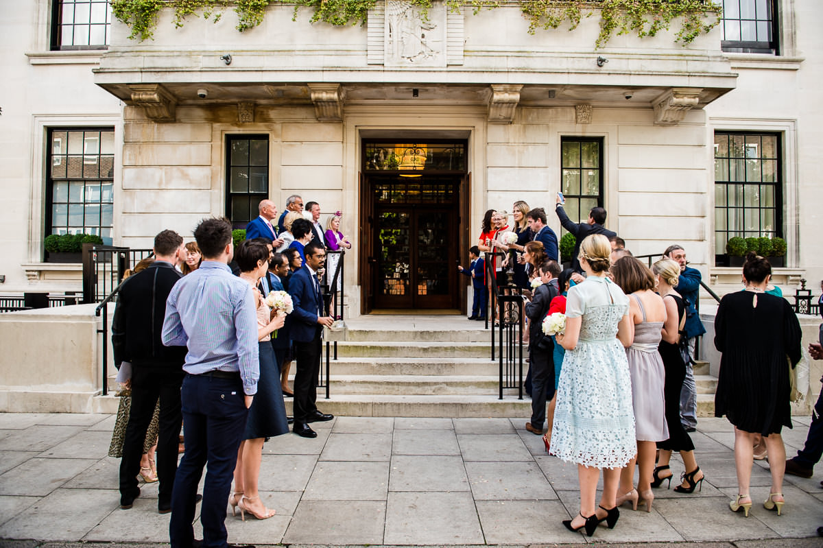 Bethnal Green Town Hall Hotel wedding families waiting outside with confetti