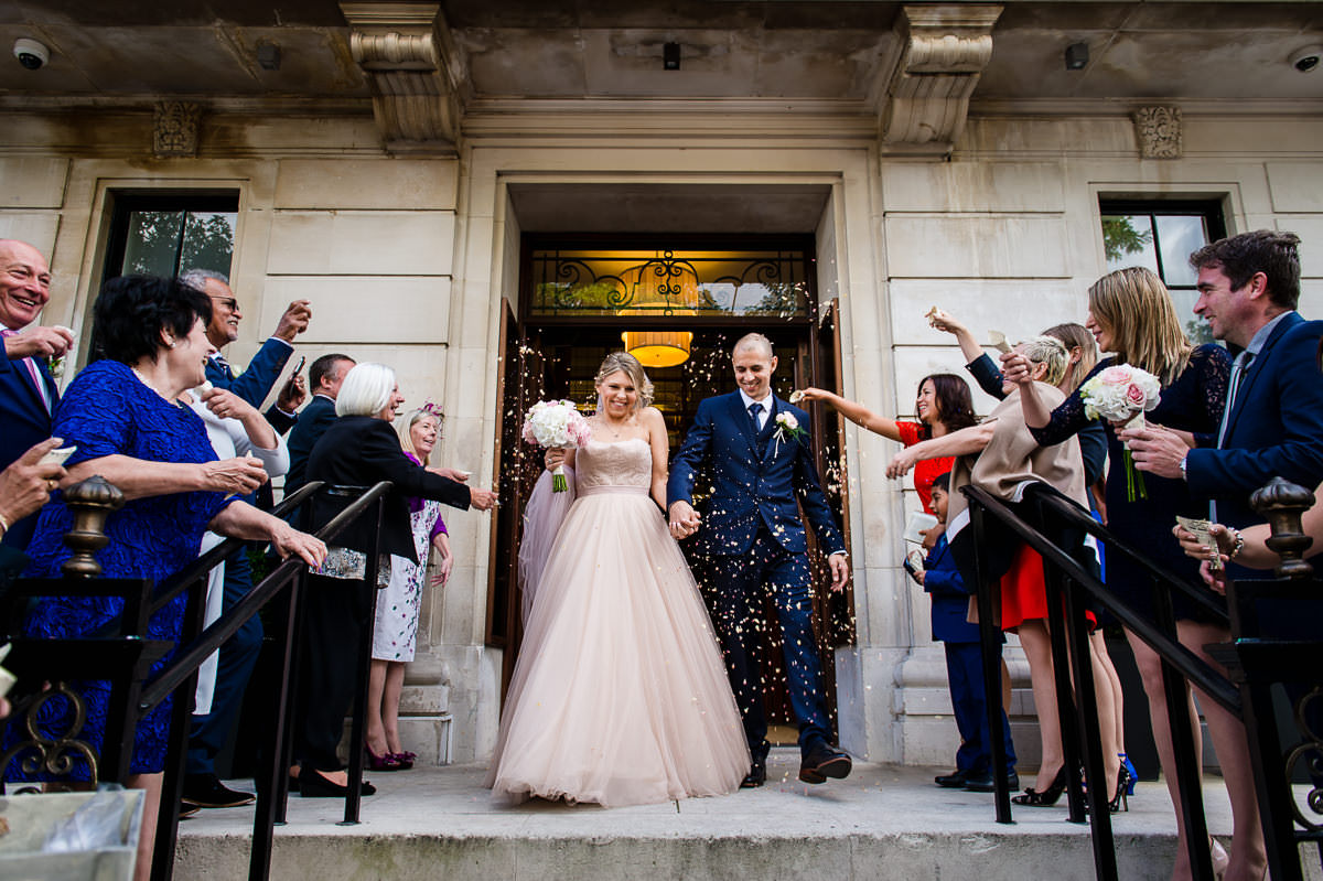 Town Hall Hotel wedding guests throwing confetti over bride and groom 