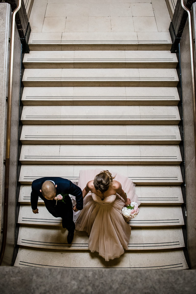 Town Hall Hotel wedding bride and groom walking down the stairs inside the town hall