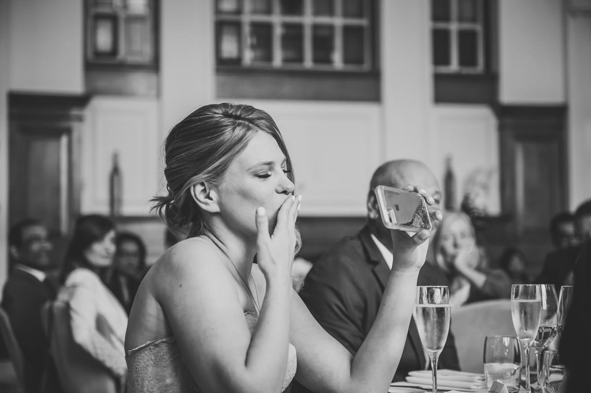 bride blowing a kiss to a wedding guest at town hall hotel