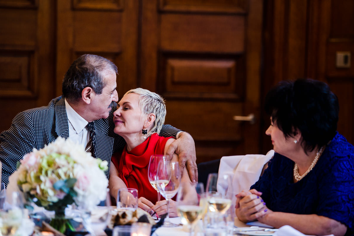Guests kissing at a town hall hotel wedding
