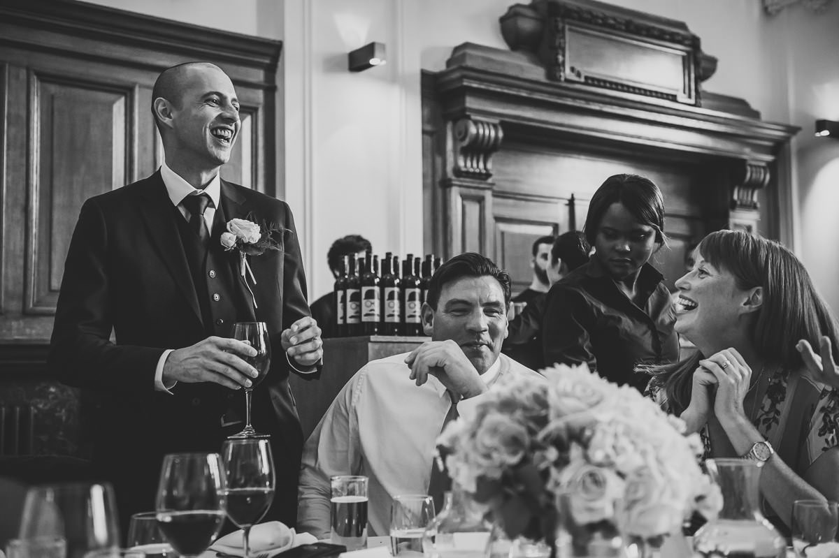 Groom and guests laughing at wedding at town hall hotel