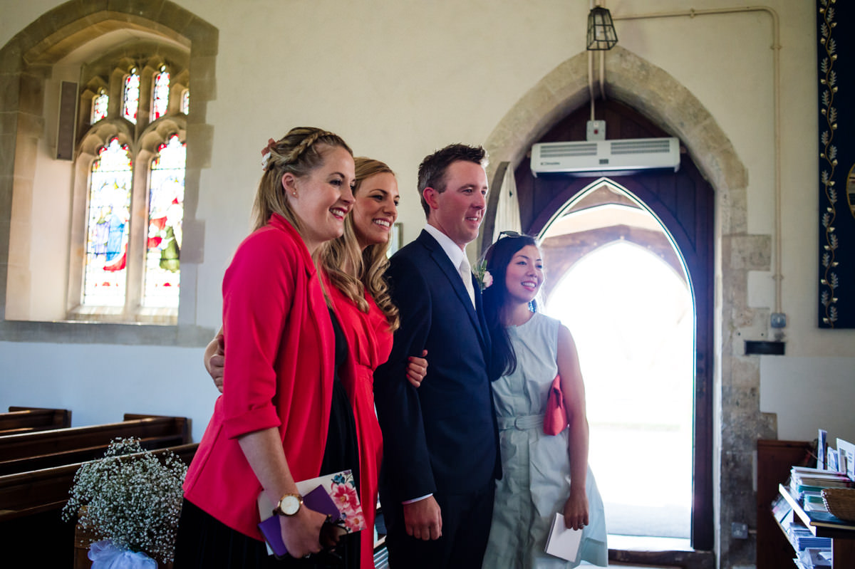 groom having his photo taken with guests before his wedding