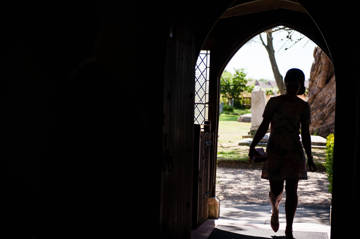 late wedding guest arrives at church in doorway