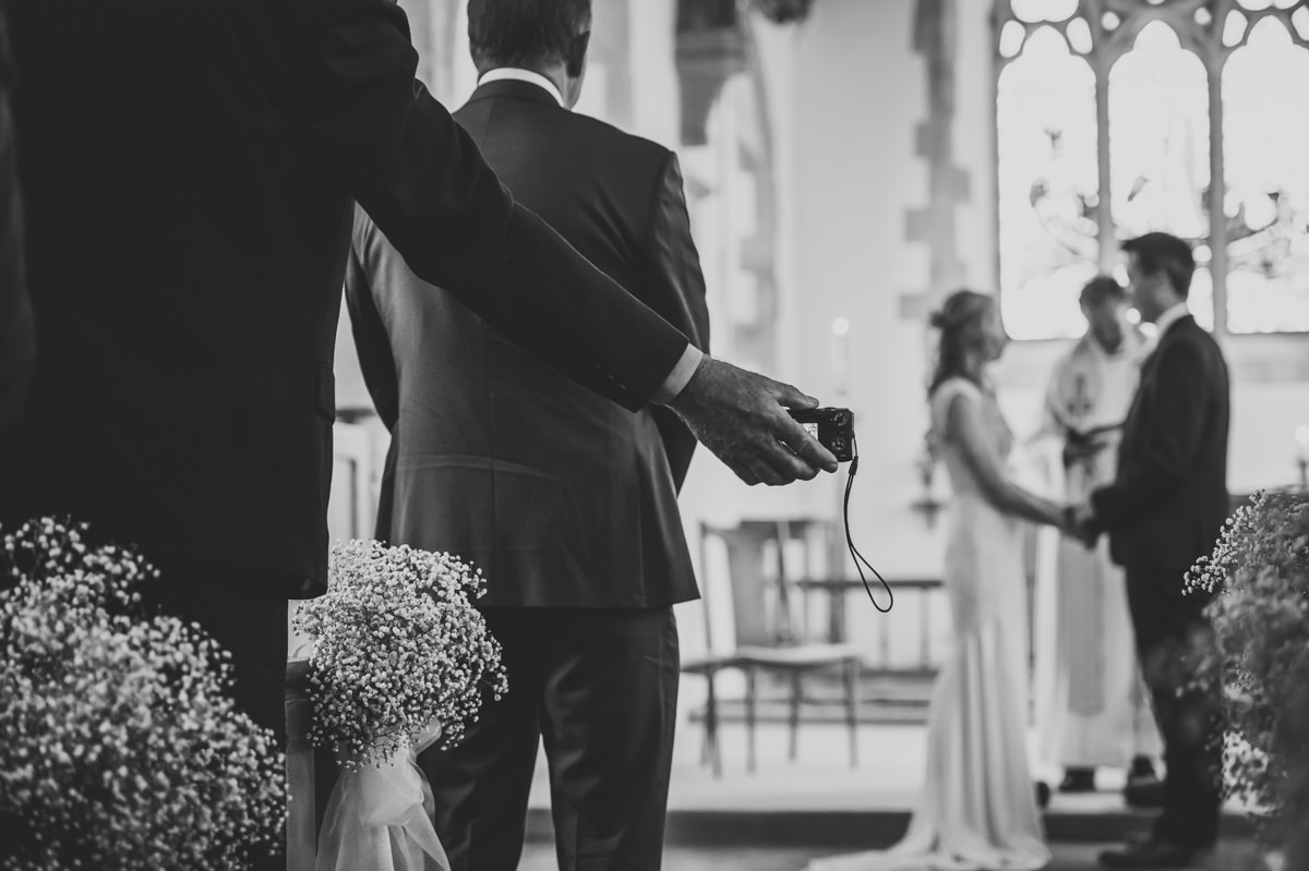 Guest filming wedding ceremony