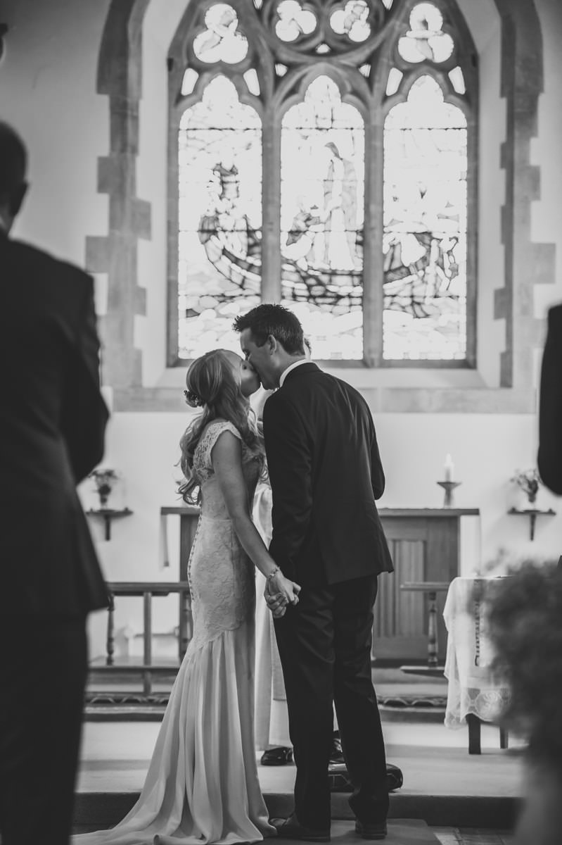 newly weds kissing as they are announced man and wife