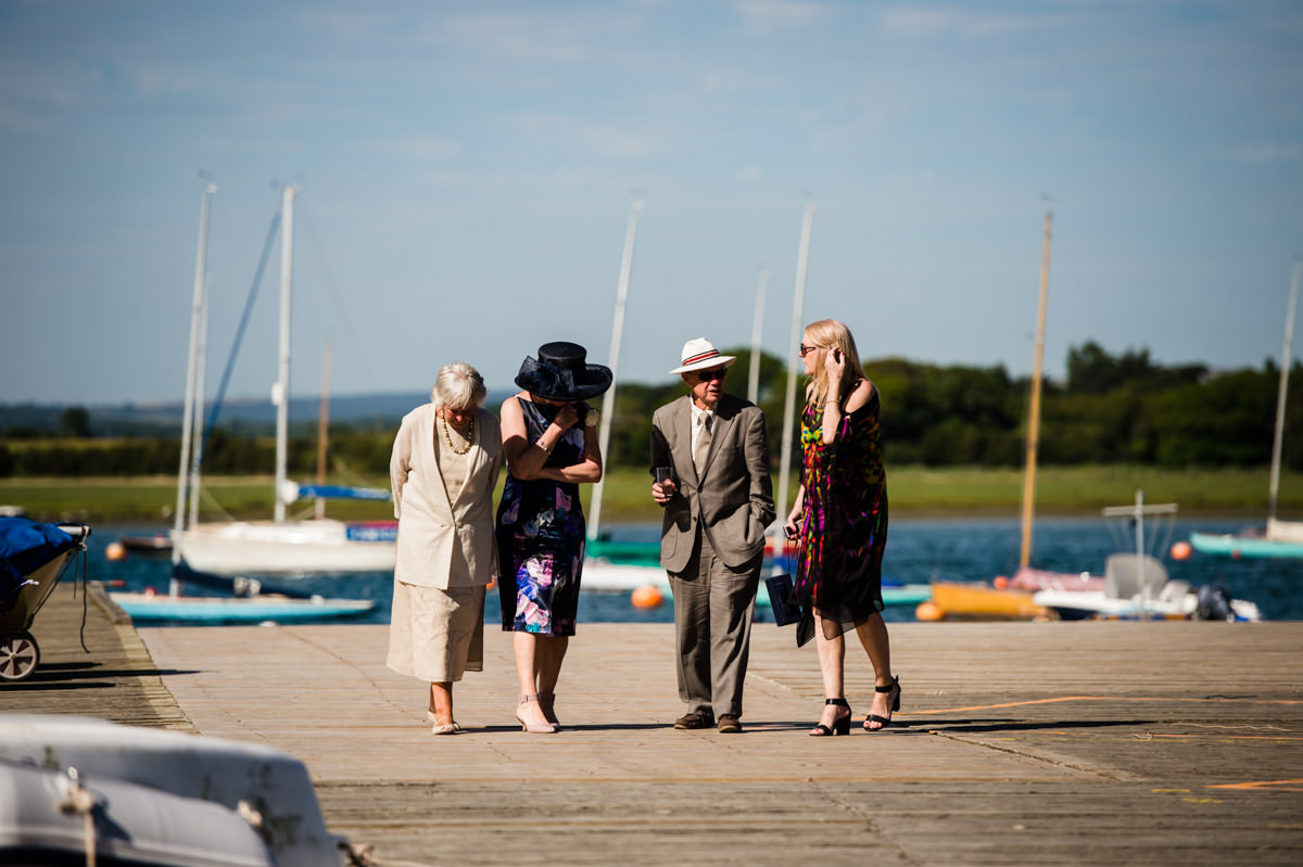 Weddings guests walking at Itchenor Sailing Club