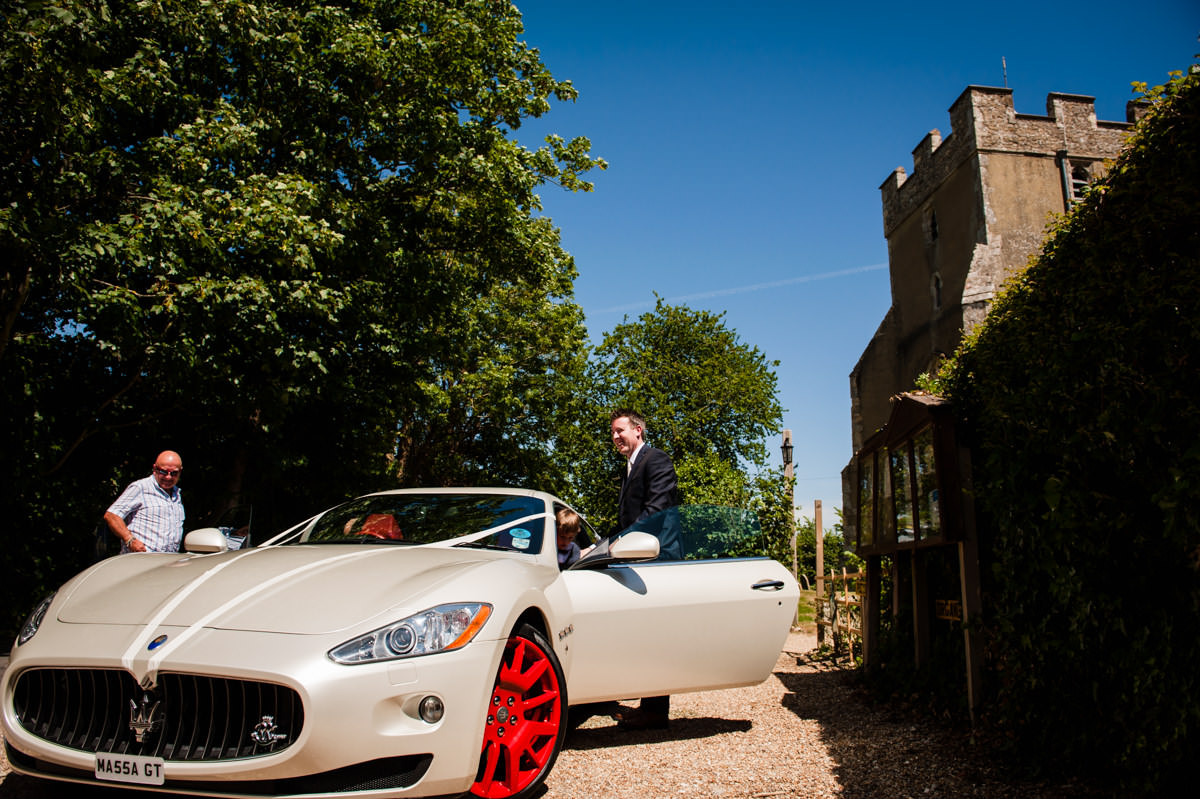 groom arrives in style in a wedding maserati