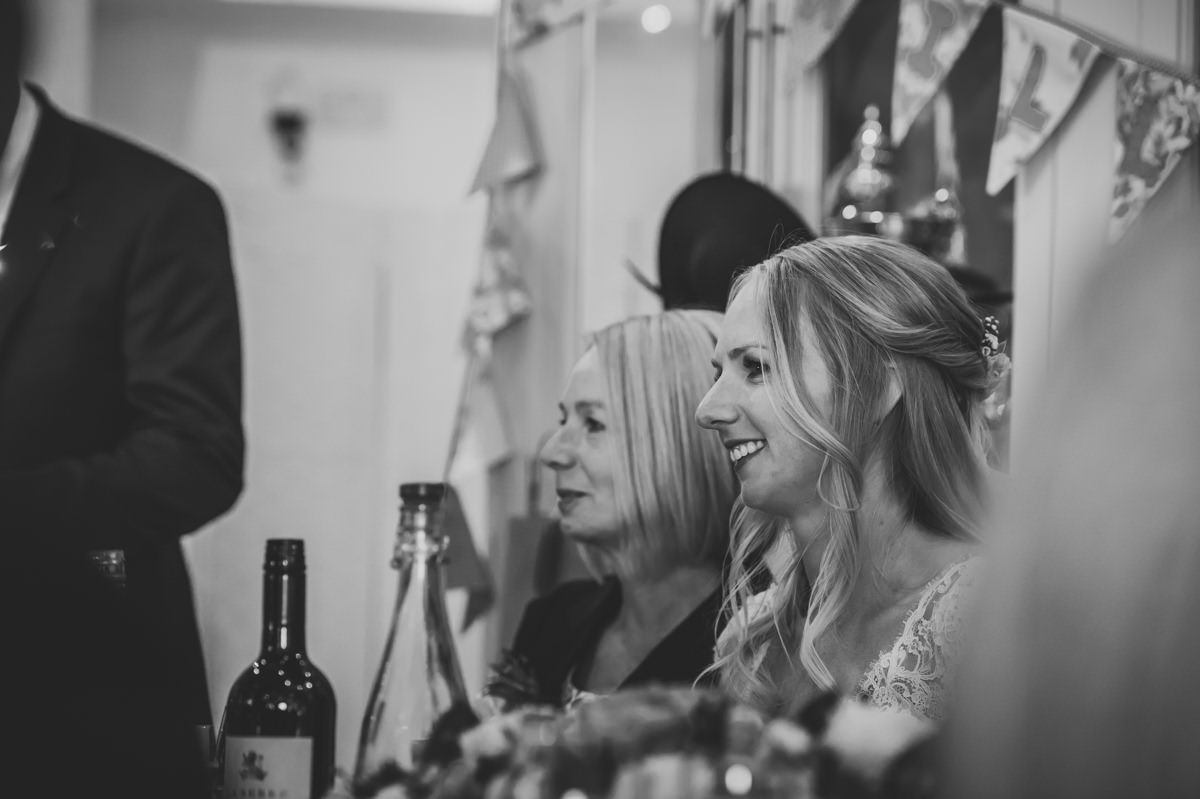 Bride listening to wedding speech from her Dad at Itchenor Sailing Club