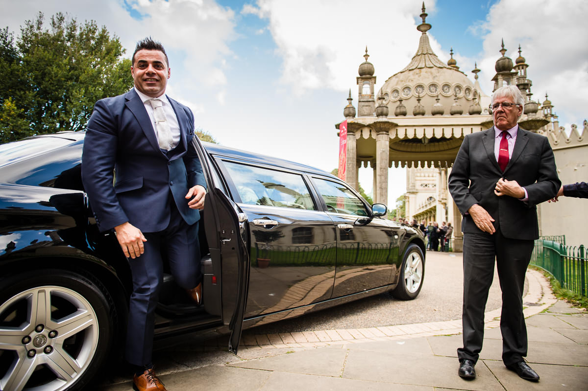 Groom gets out of bentley car ready to enter the royal pavilion
