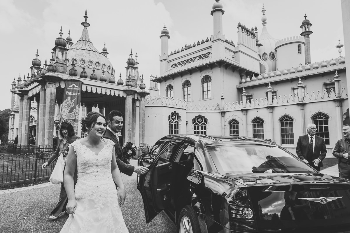 Bride and Groom smiling at family as they arrive at their wedding