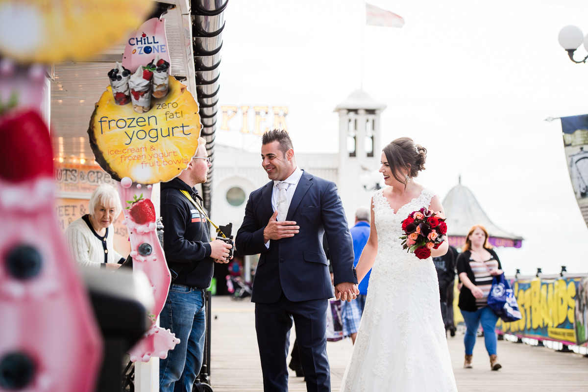 Newly weds on brighton pier after their wedding ceremony