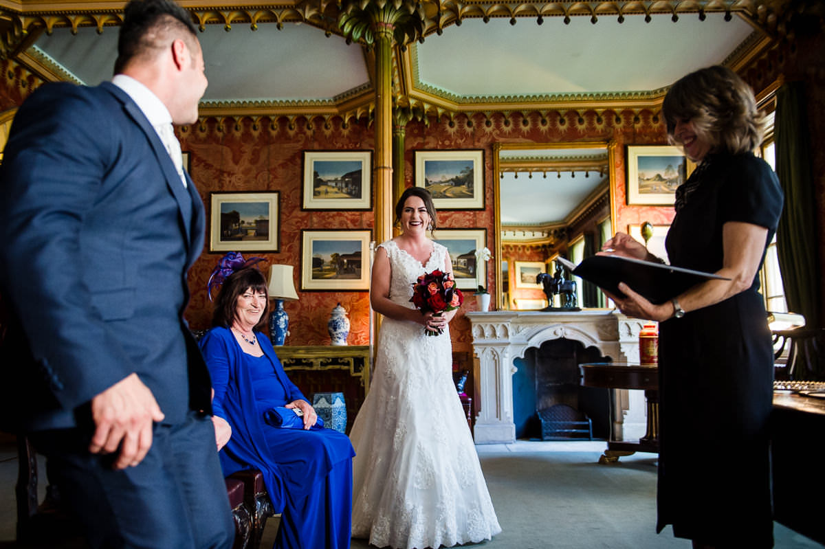 Bride enters the red drawing room with her flowers, to start the wedding ceremony