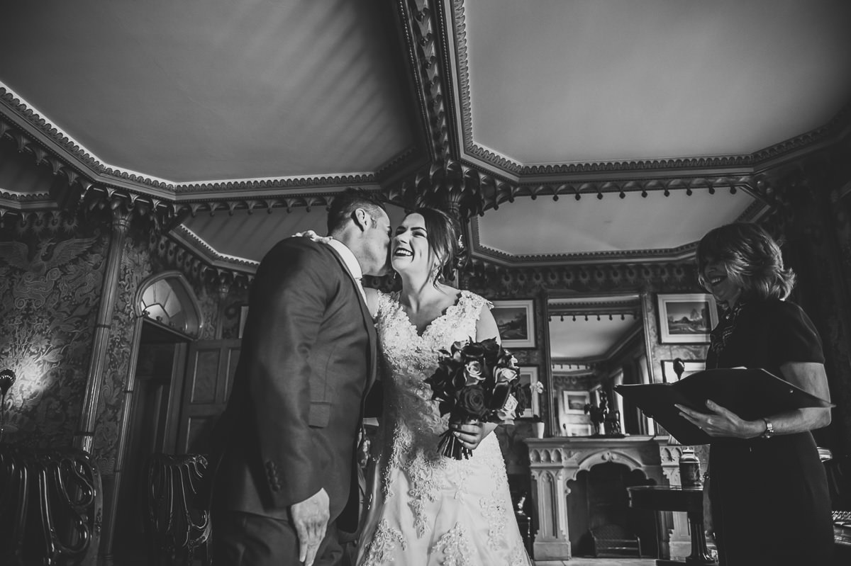 Bride and groom kiss before ceremony