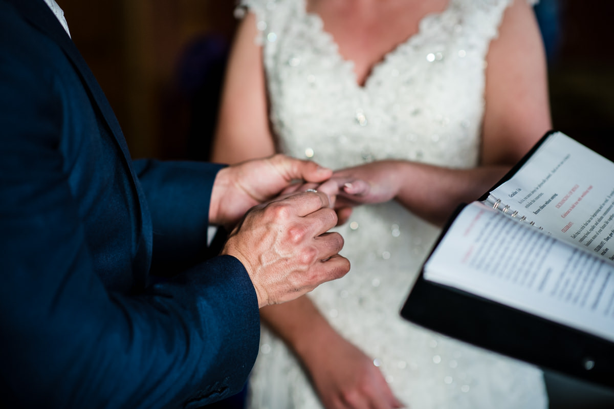 Dany places wedding ring on Geraldine's finger at their wedding ceremony