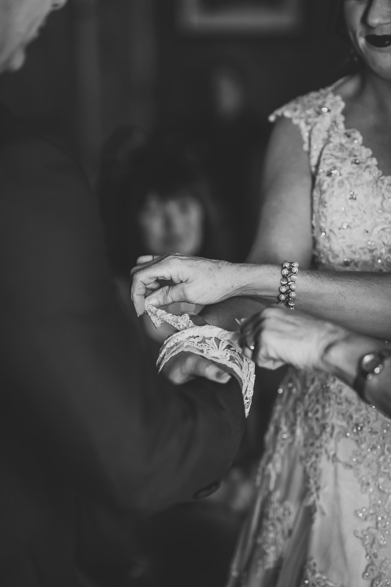 Bride and Groom's hands are hand-fasted with lace ribbon at their humanist wedding ceremony