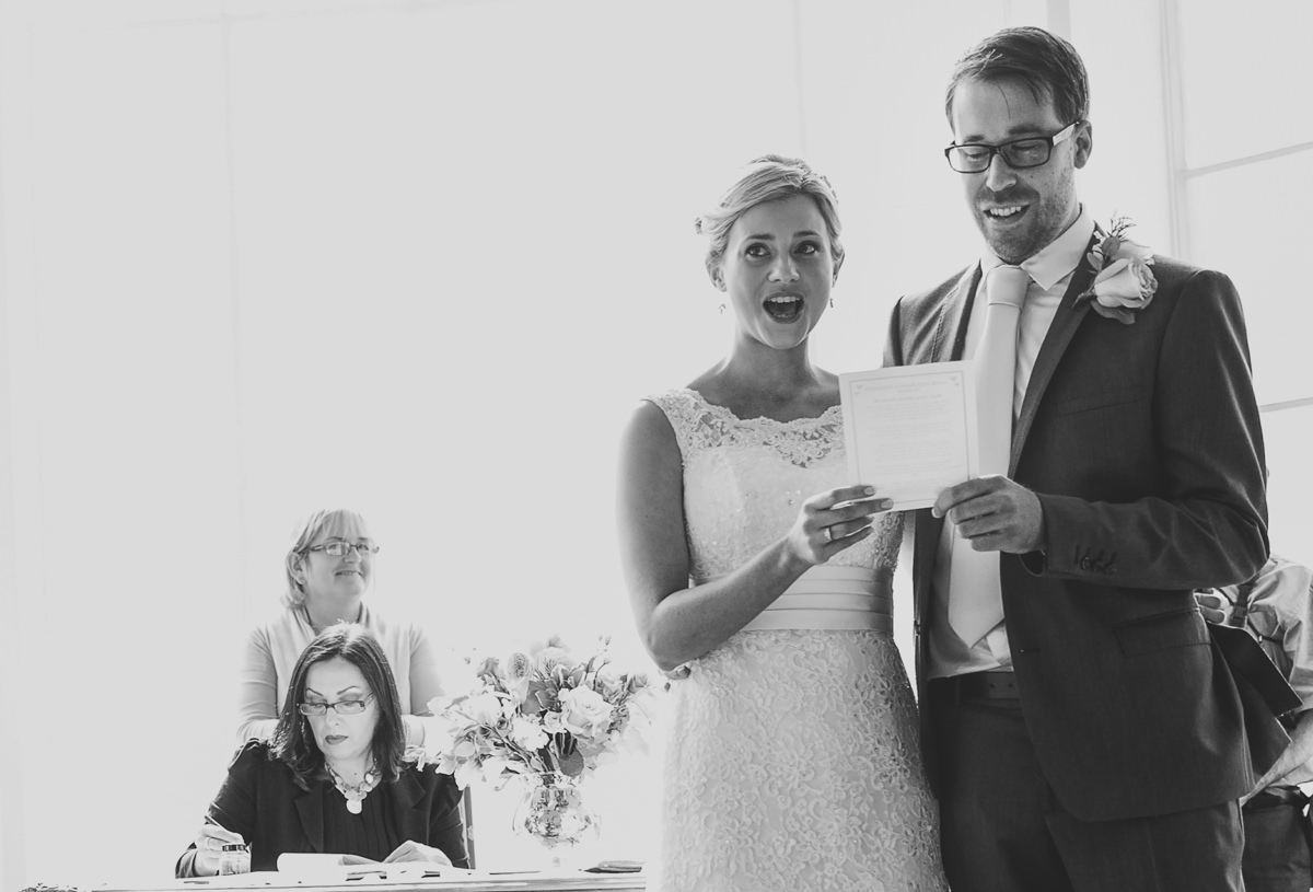 bride and groom singing at their wedding ceremony at additington palace