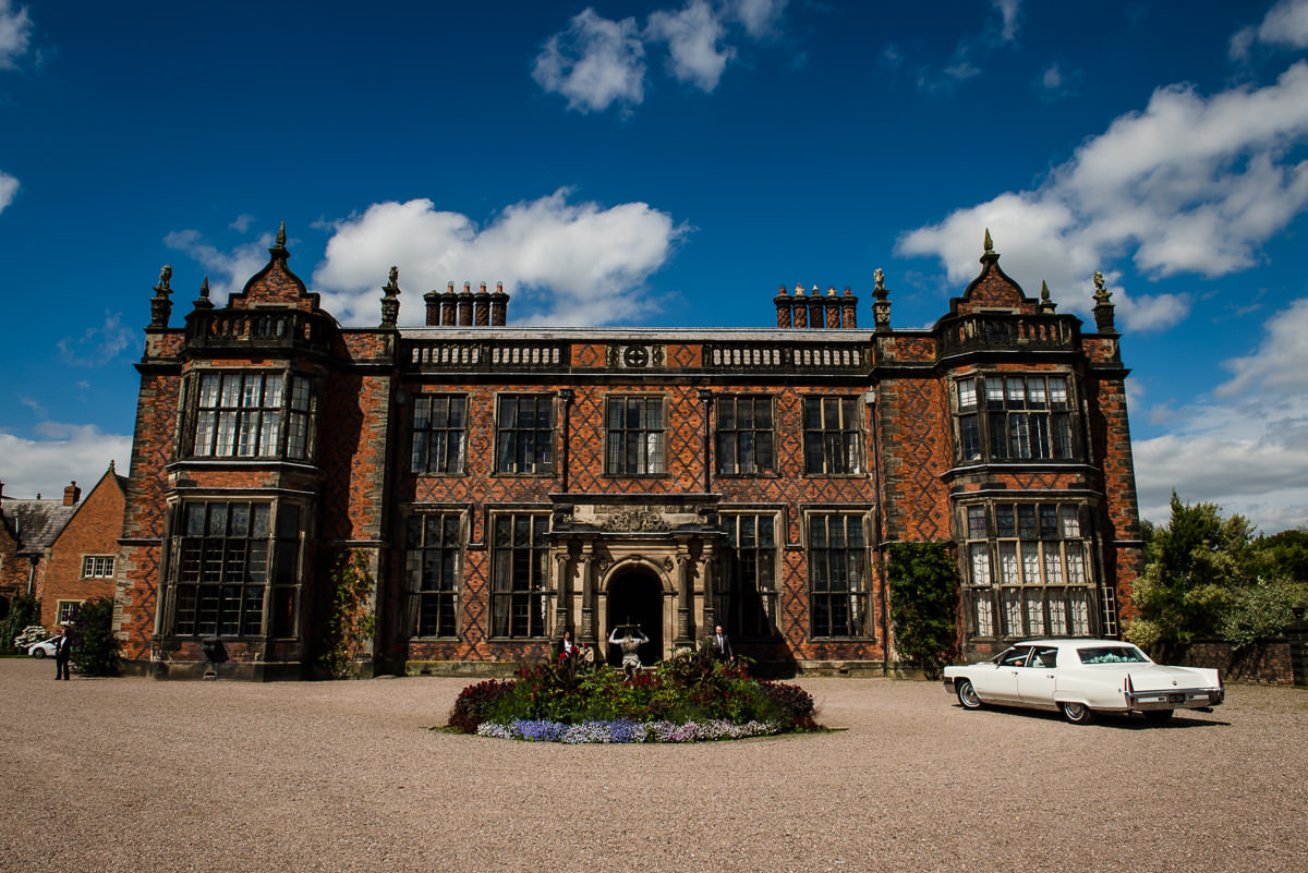 Bride & Groom arriving at their Arley Hall & Gardens Wedding in a Chevrolet