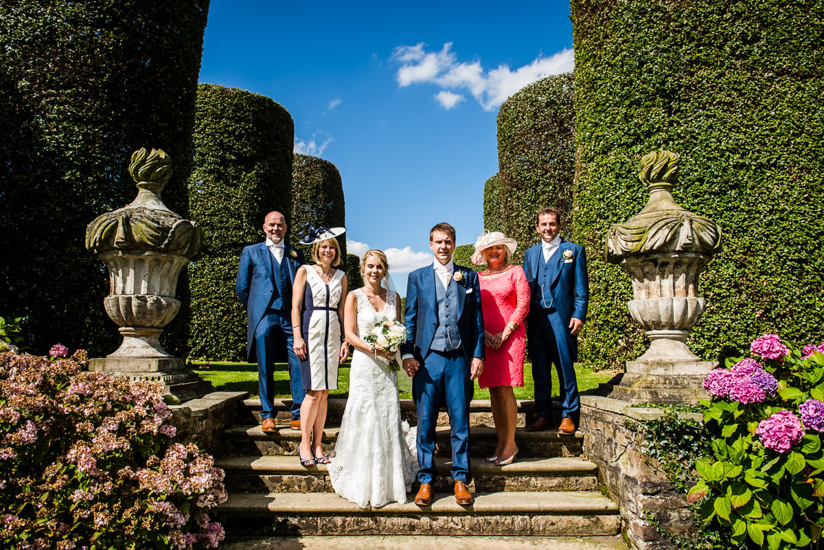 Bride & Groom with their families in the gardens of Arley Hall