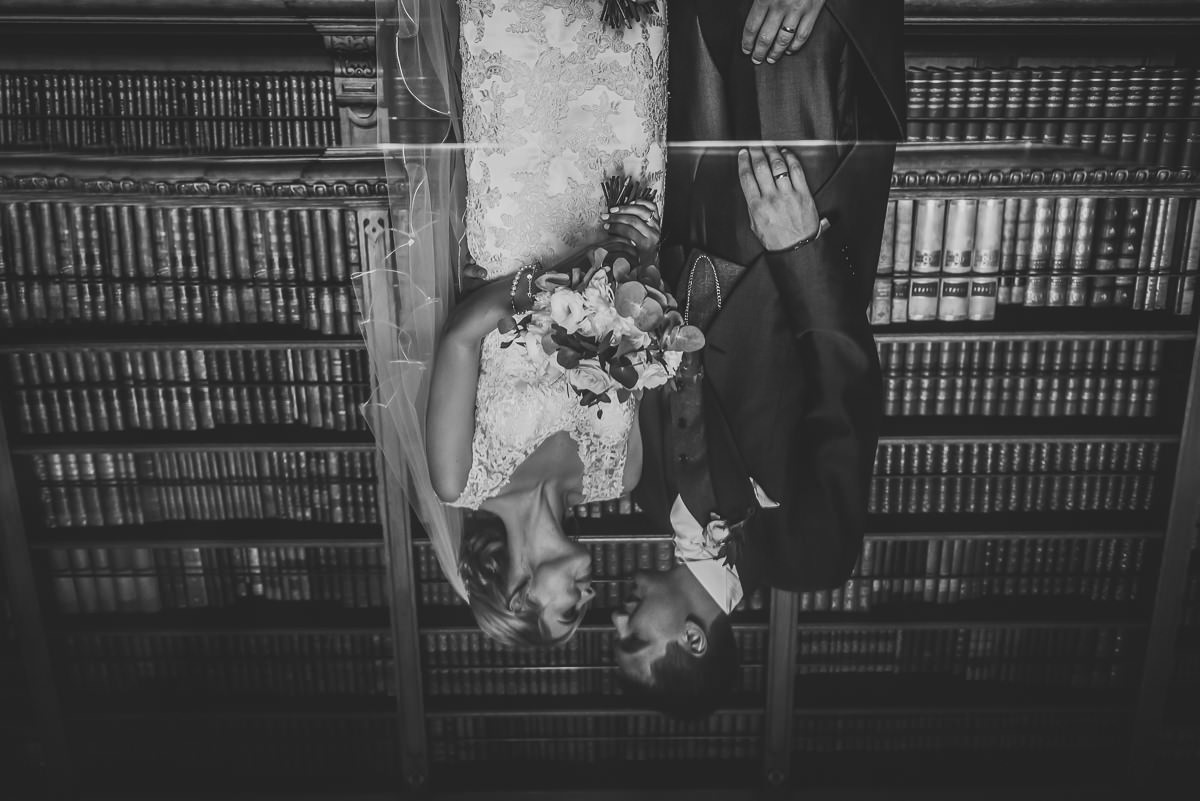 Reflection of Bride & Groom in the library at Arley Hall & Gardens wedding
