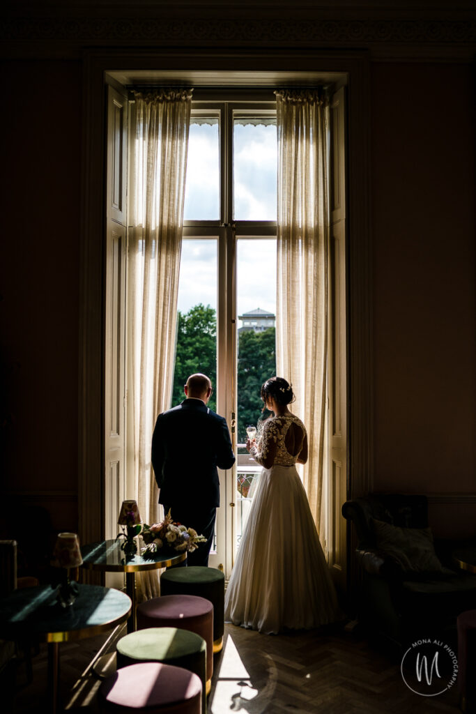 bride and groom having a quite moment drinking champagne at their bingham hotel wedding