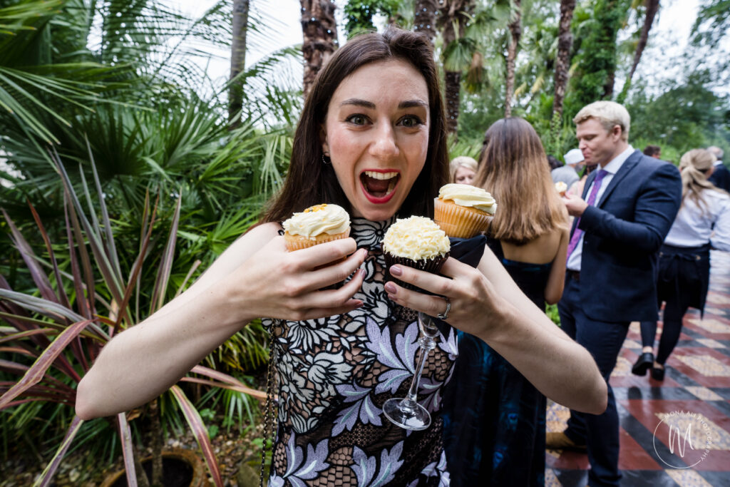 wedding guest with too many cakes in her hands