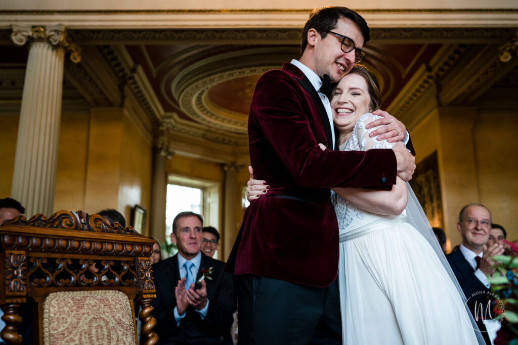 Bride and groom hugging after saying I DO at their Hampton Court House wedding