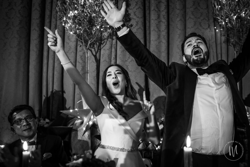 Bride and groom singing at their wedding reception at Hampton Court House