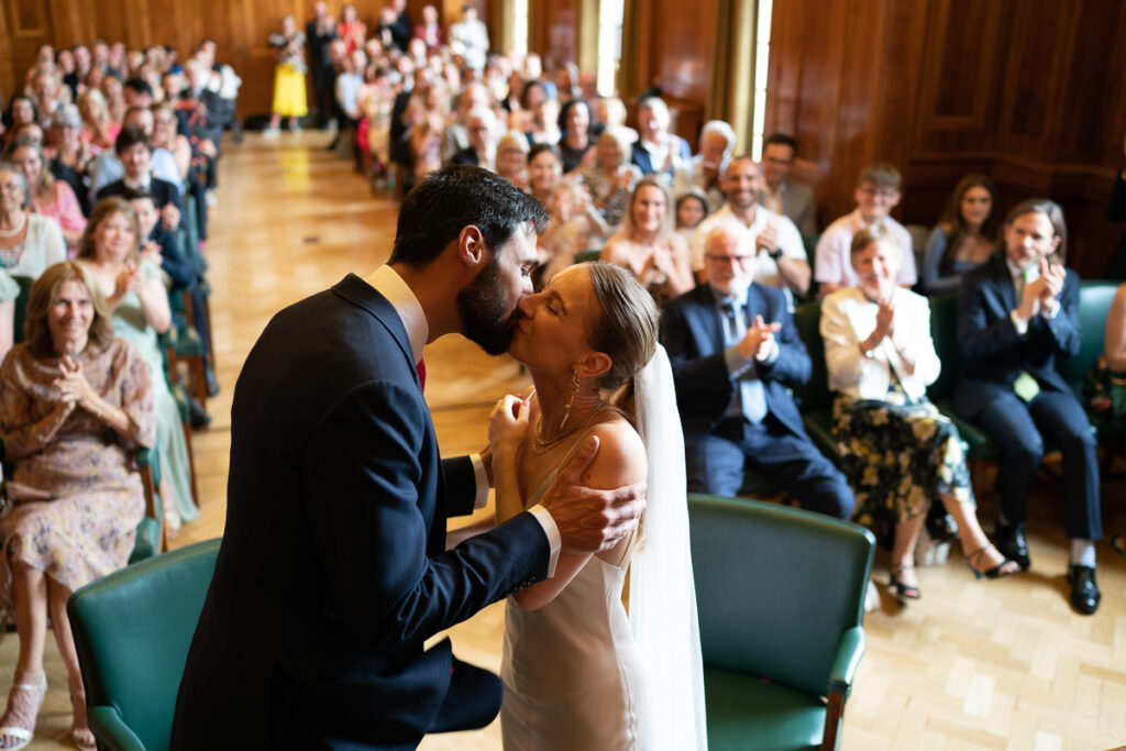 Bride and groom kissing at their wedding ceremony at Hackney Town Hall